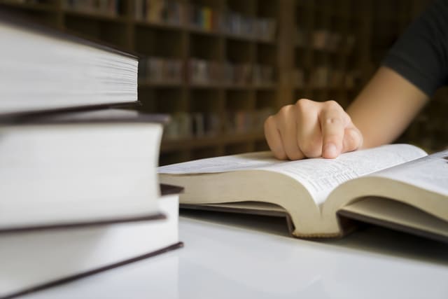 640-close-up-of-a-person-reading-at-a-library